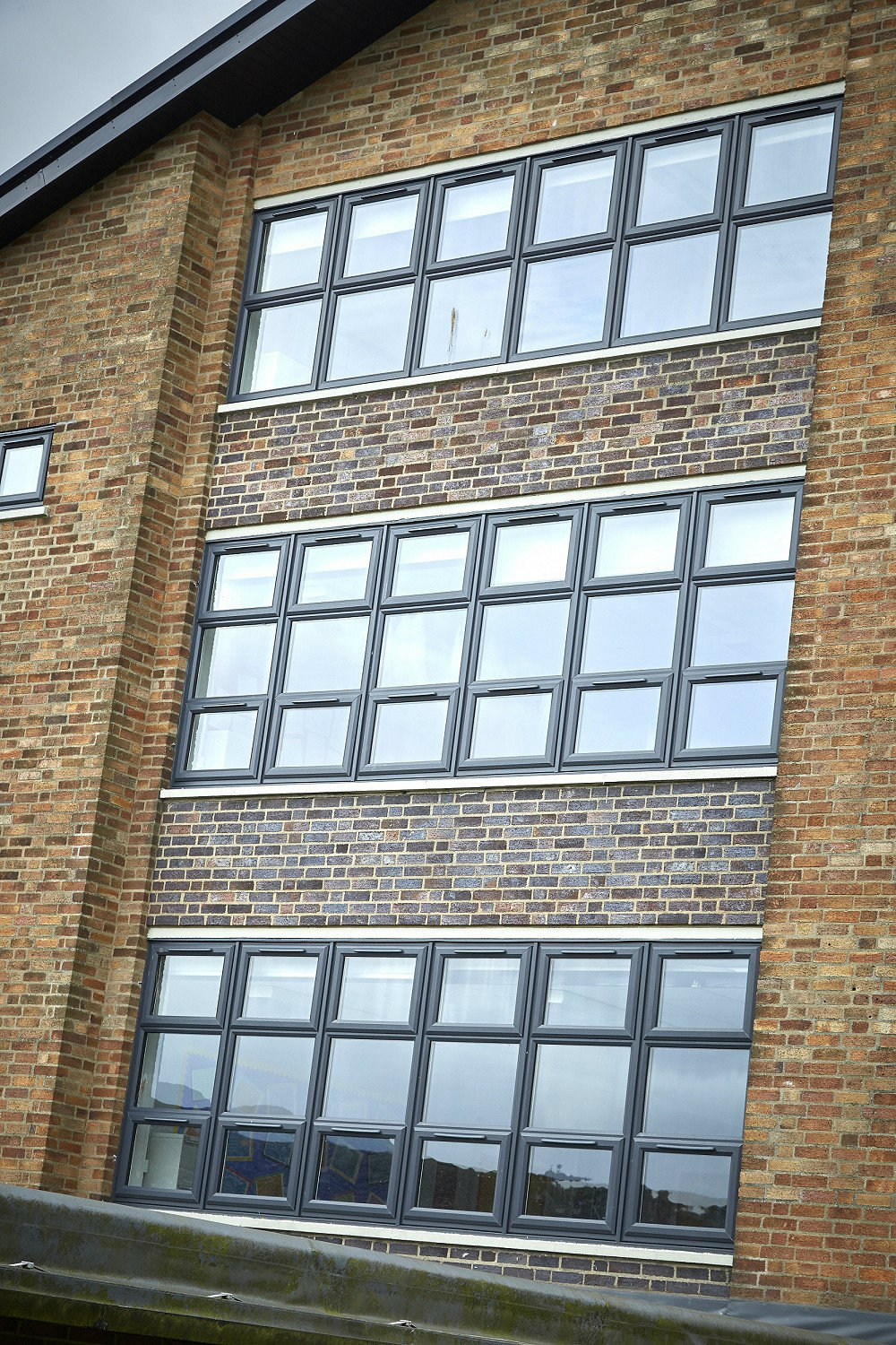 Grey UVC windows on a newly-revamped school building