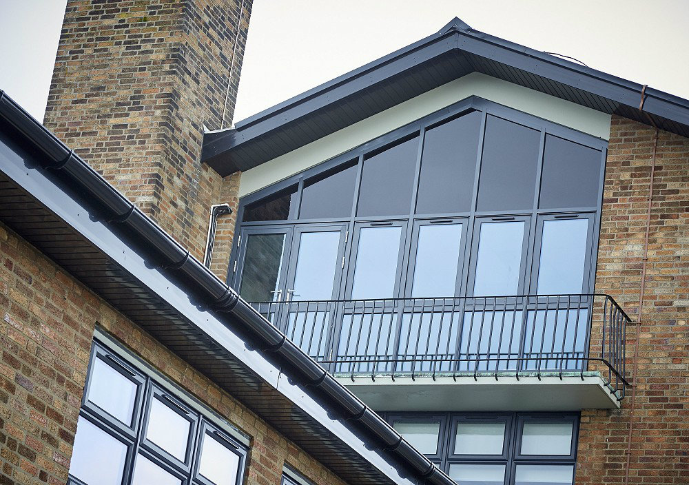 Grey UPVC windows and grey aluminium curtain walling on a school in east Yorkshire