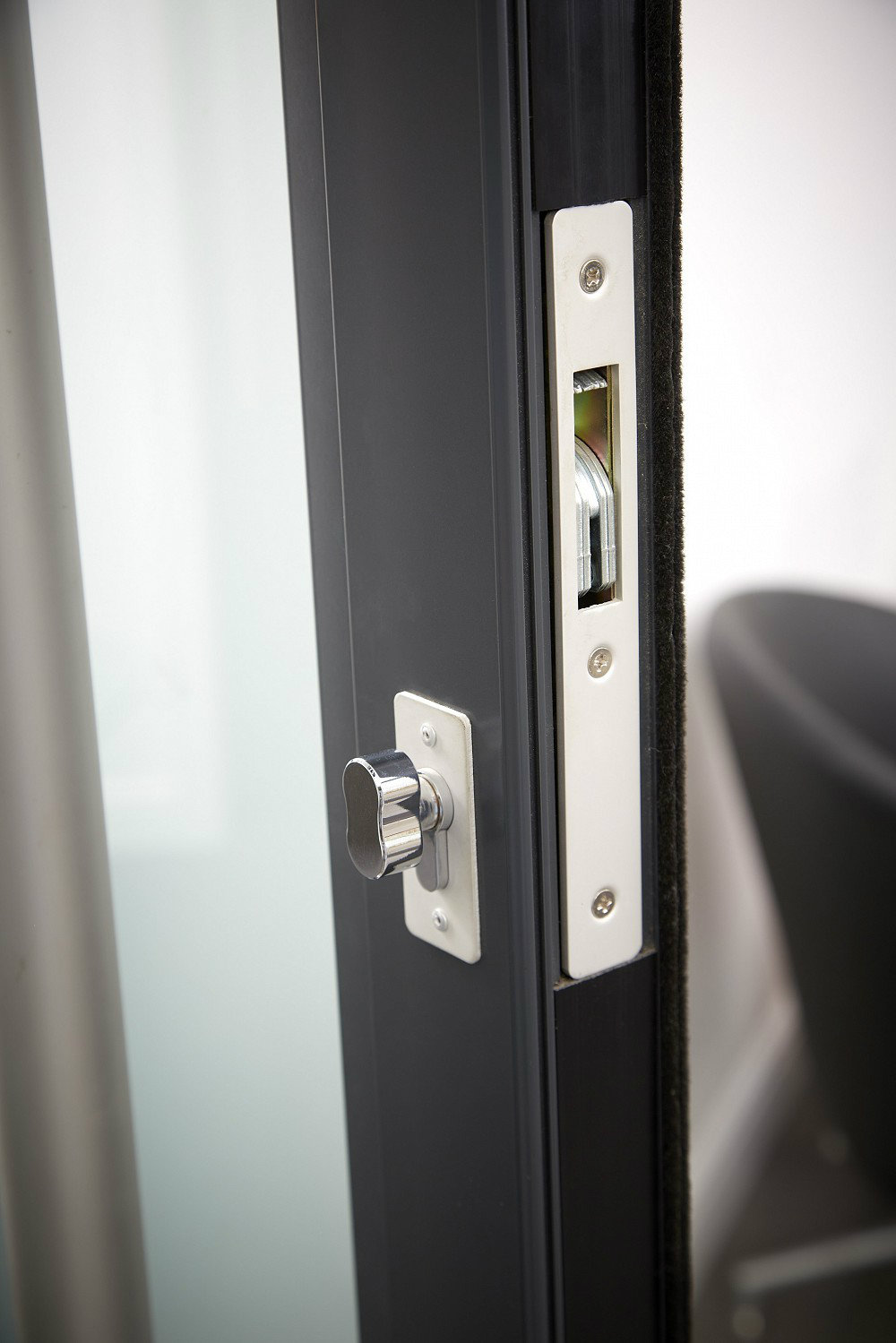 Close-up image of the locking mechanism on an aluminium entrance door